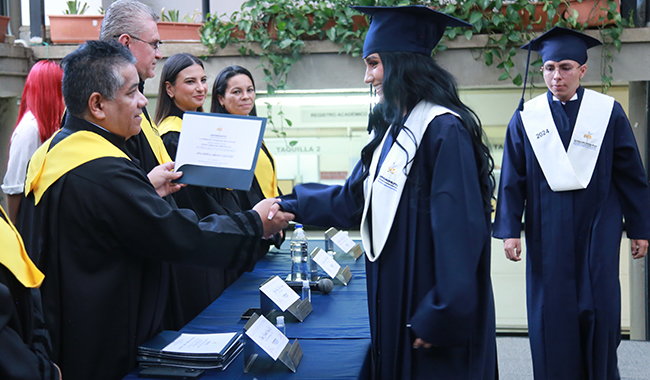 Rector de UNIMINUTO Seccional Antioquia - Chocó entregando certificados a los estudiantes.