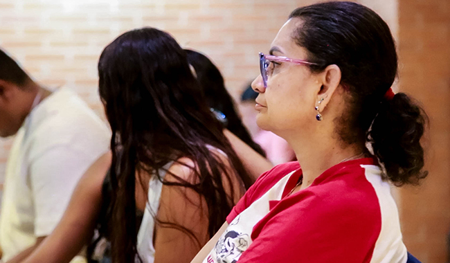 Asistente escuchando atenta las temáticas del encuentro por la paz de UNIMINUTO Seccional Antioquia - Chocó
