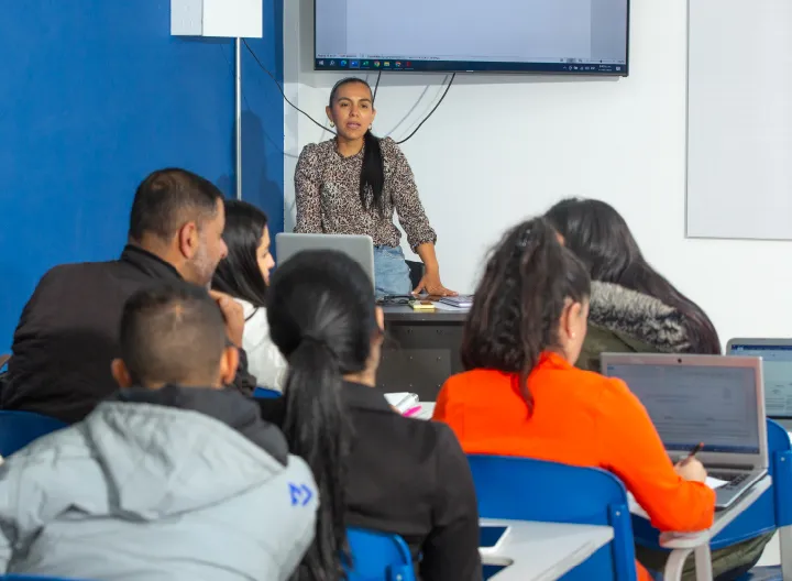 profesora dictando clase en un salón